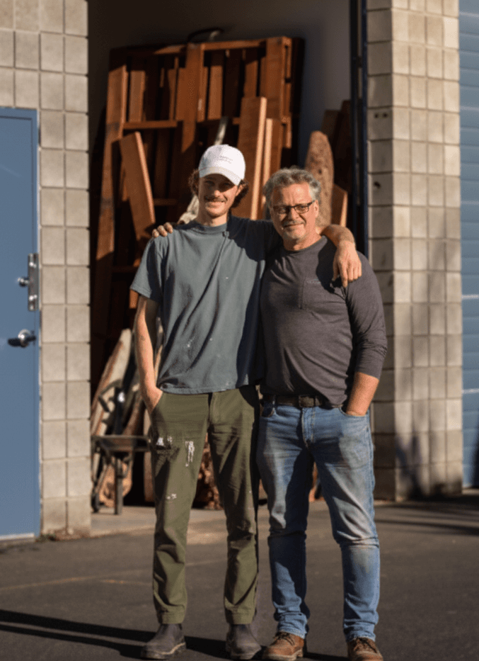 Tim Tchida standing with Jake outside the workshop
